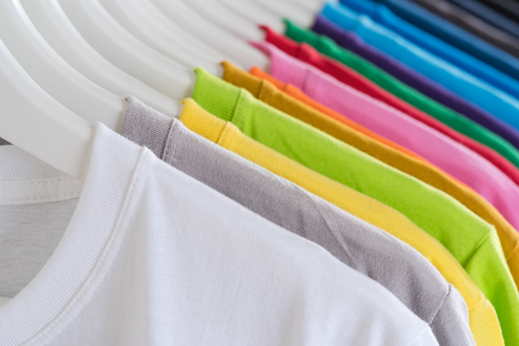 Minimalist multicolored t shirts on hangers